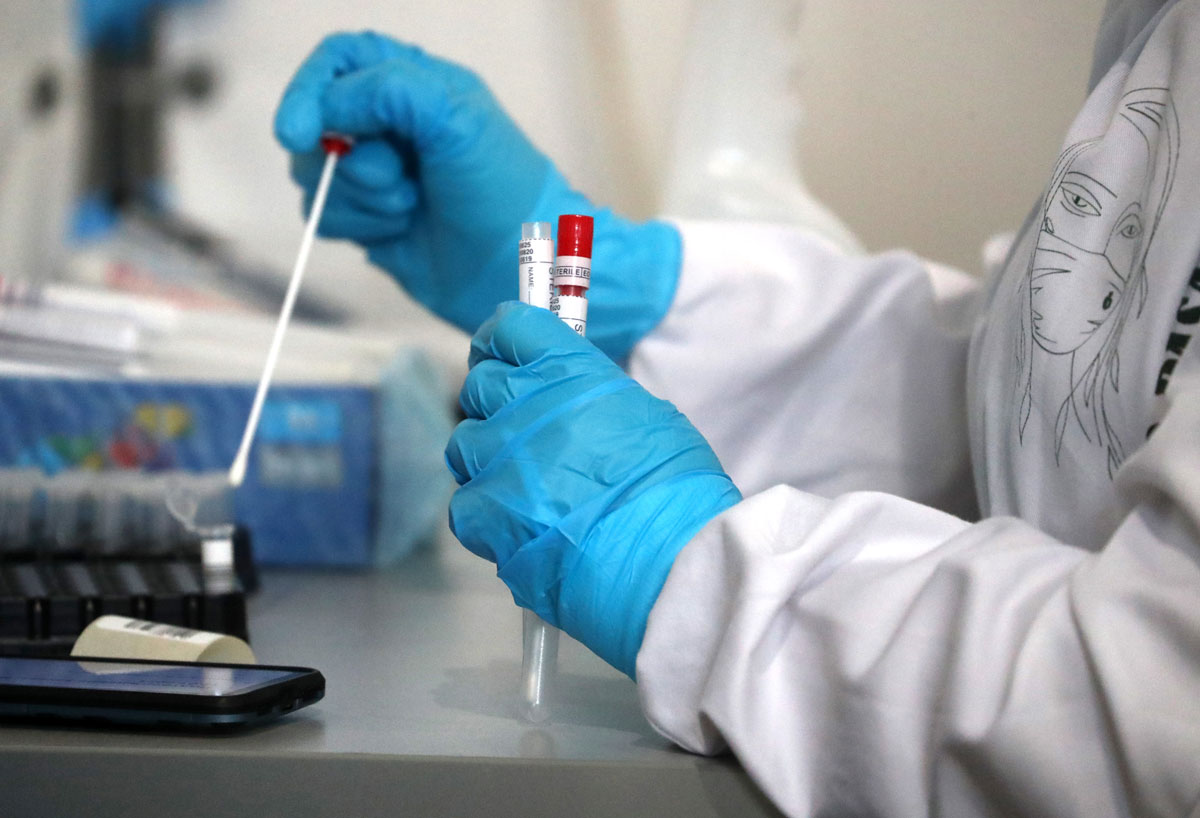 A medical worker handles samples at an express Covid-19 testing lab at Vnukovo International Airport on January 12.